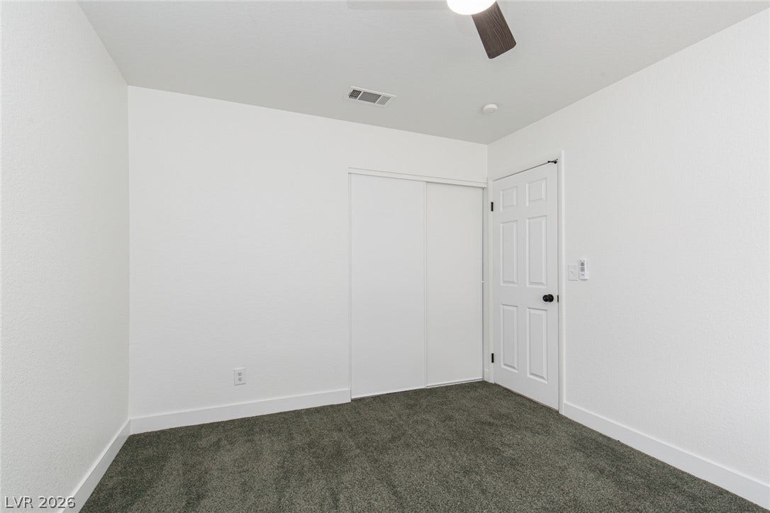 352 Lander Drive, Henderson, NV 89074 Plush carpeting and crisp white walls define this versatile secondary bedroom space.