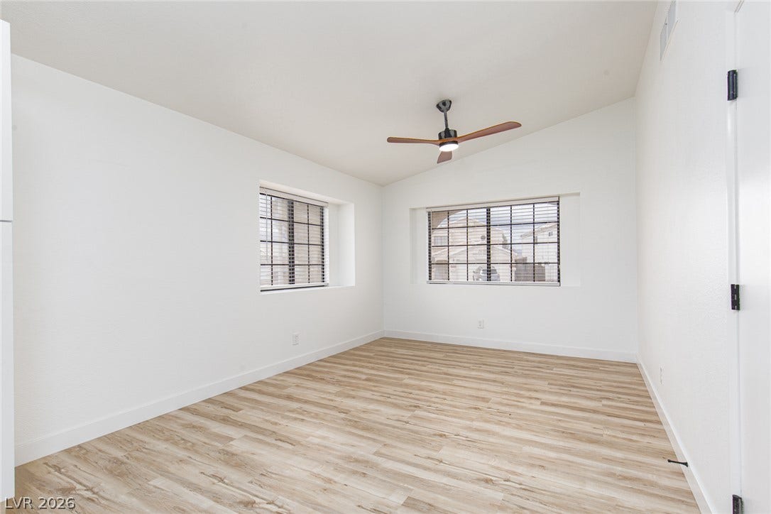 352 Lander Drive, Henderson, NV 89074 A vaulted ceiling and wood-finish flooring highlight this airy, light-filled bedroom space.