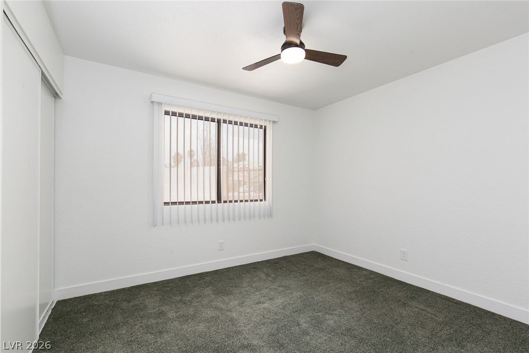 352 Lander Drive, Henderson, NV 89074 Plush carpeting anchors this clean-lined bedroom under a classic window overlooking the neighborhood.