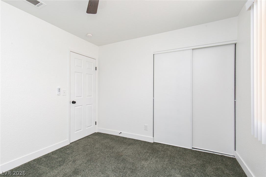 352 Lander Drive, Henderson, NV 89074 Plush carpeting anchors this versatile room with a sliding door closet.