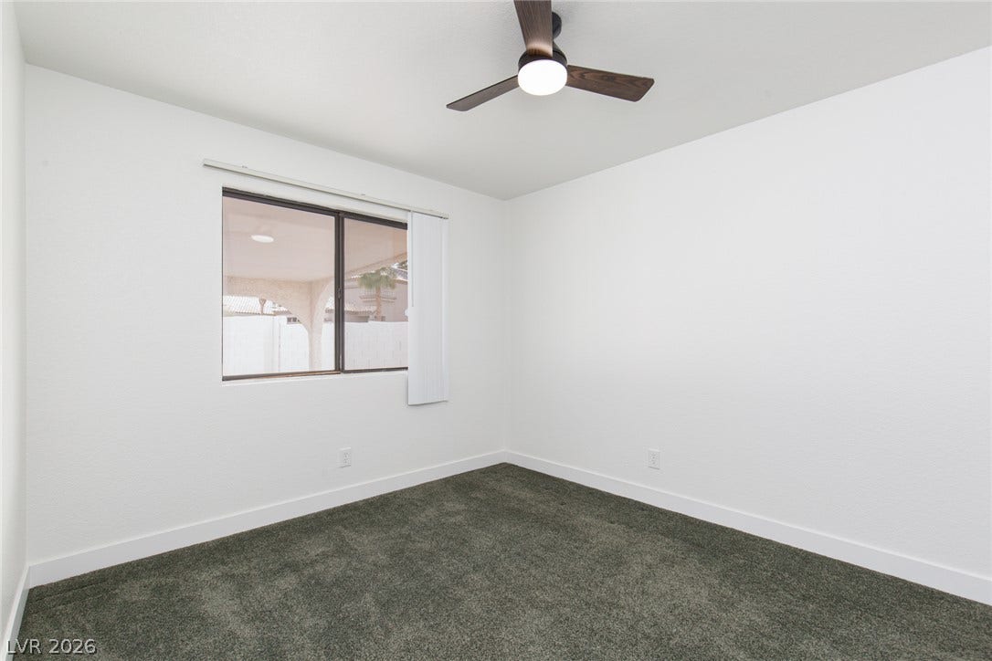 352 Lander Drive, Henderson, NV 89074 Plush carpeting anchors this quiet bedroom filled with natural light.