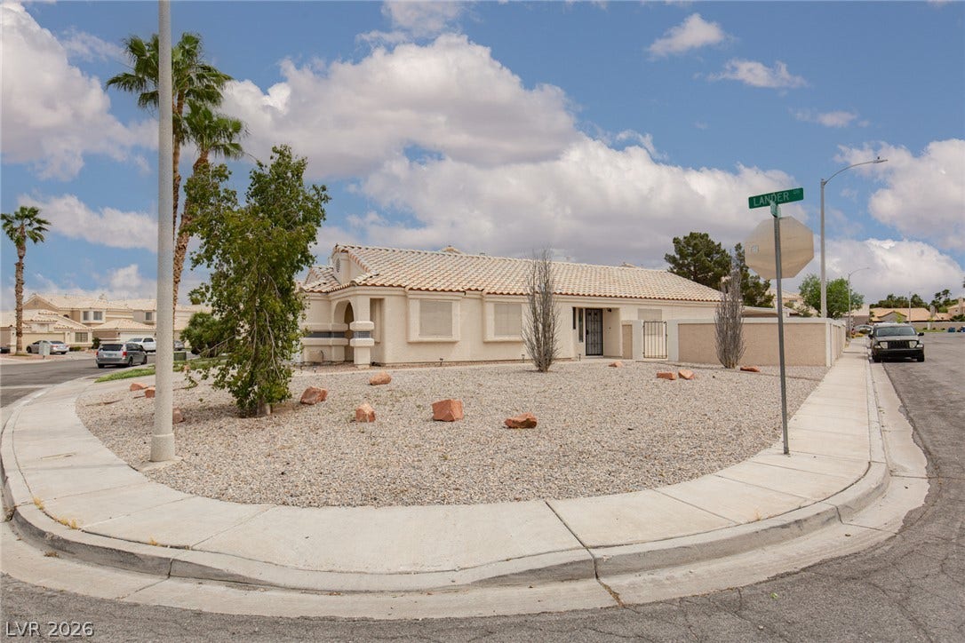 352 Lander Drive, Henderson, NV 89074 A classic stucco exterior with Spanish tile roofing defines this low-maintenance corner lot property.