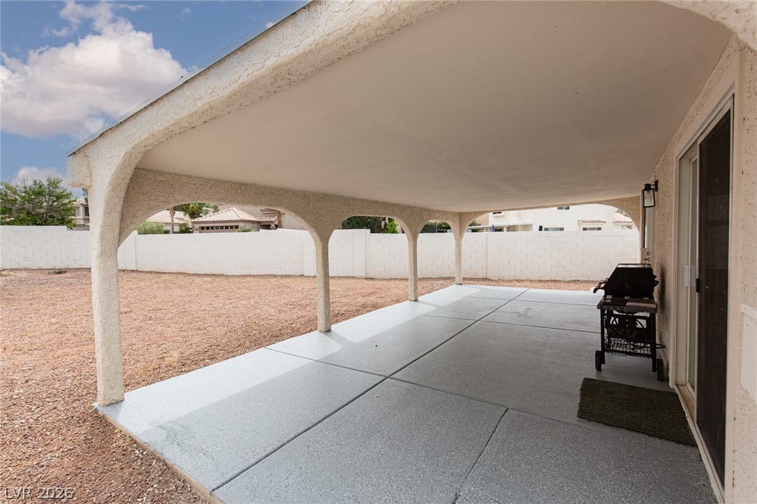 352 Lander Drive, Henderson, NV 89074 An arched patio cover shades the concrete terrace overlooking a spacious yard.