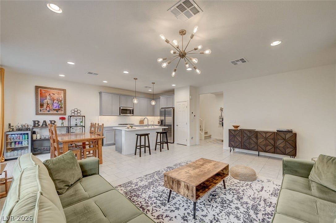 4114 Billowing Breeze Avenue, North Las Vegas, NV 89081 An open floorplan seamlessly connects the casual living area to a modern kitchen.