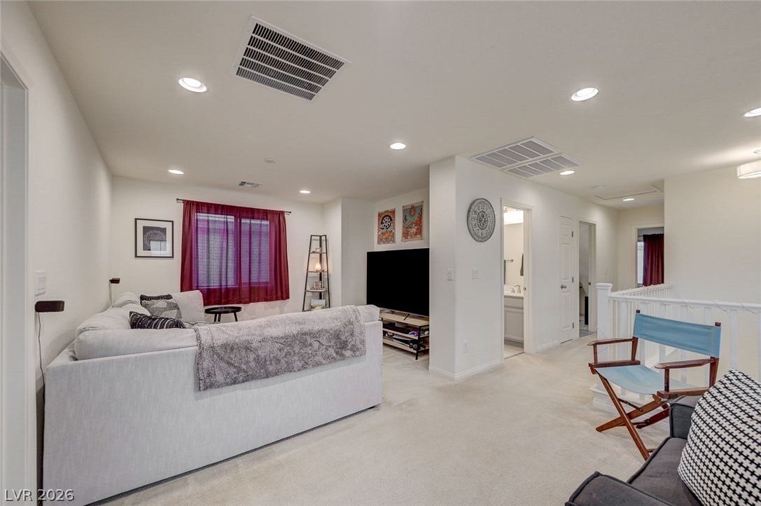 4114 Billowing Breeze Avenue, North Las Vegas, NV 89081 Recessed lighting illuminates this versatile upstairs loft area featuring plush carpeting and neutral walls.