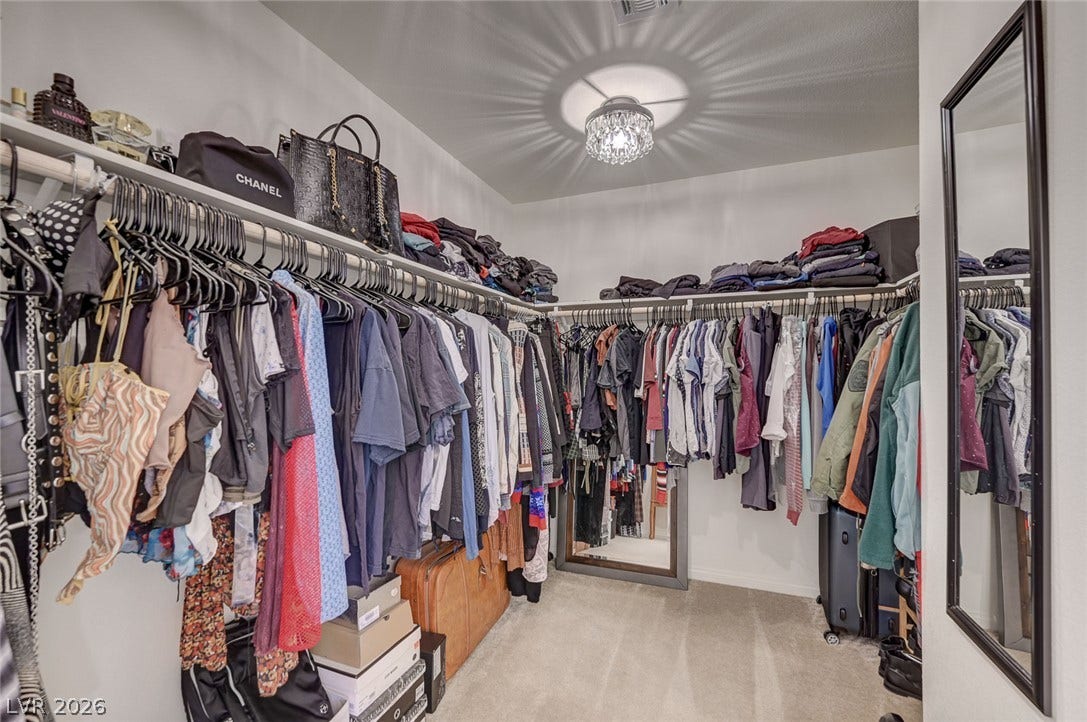 4114 Billowing Breeze Avenue, North Las Vegas, NV 89081 Ample wardrobe storage is provided by this carpeted walk-in closet featuring extensive built-in shelving.