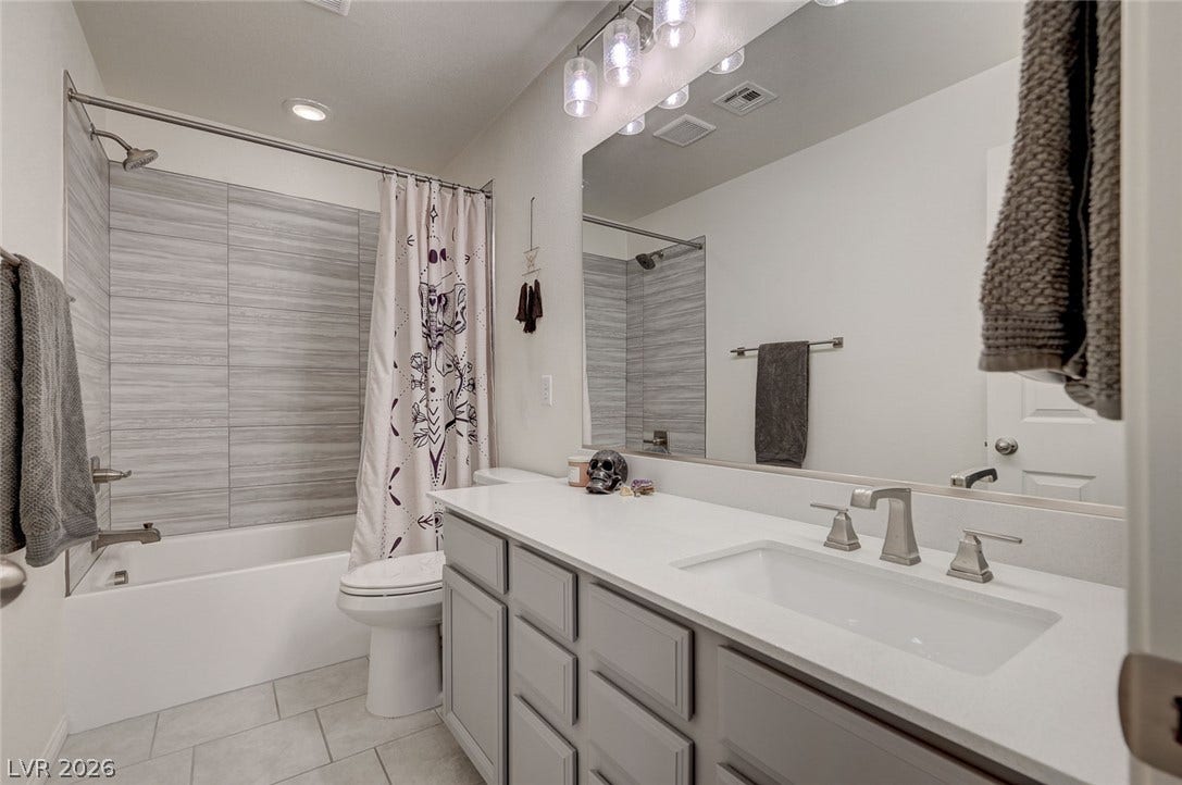 4114 Billowing Breeze Avenue, North Las Vegas, NV 89081 Tiled shower surrounds and solid surface vanity tops highlight this contemporary bathroom design.