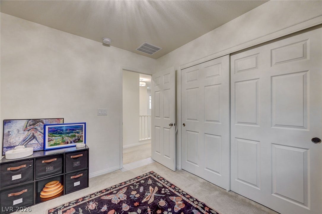4114 Billowing Breeze Avenue, North Las Vegas, NV 89081 A spacious closet with sliding doors complements this cozy room.
