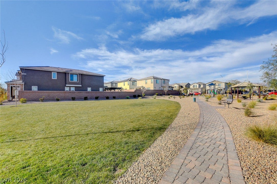 4114 Billowing Breeze Avenue, North Las Vegas, NV 89081 A paved path meanders through a grassy park area within a master-planned neighborhood.
