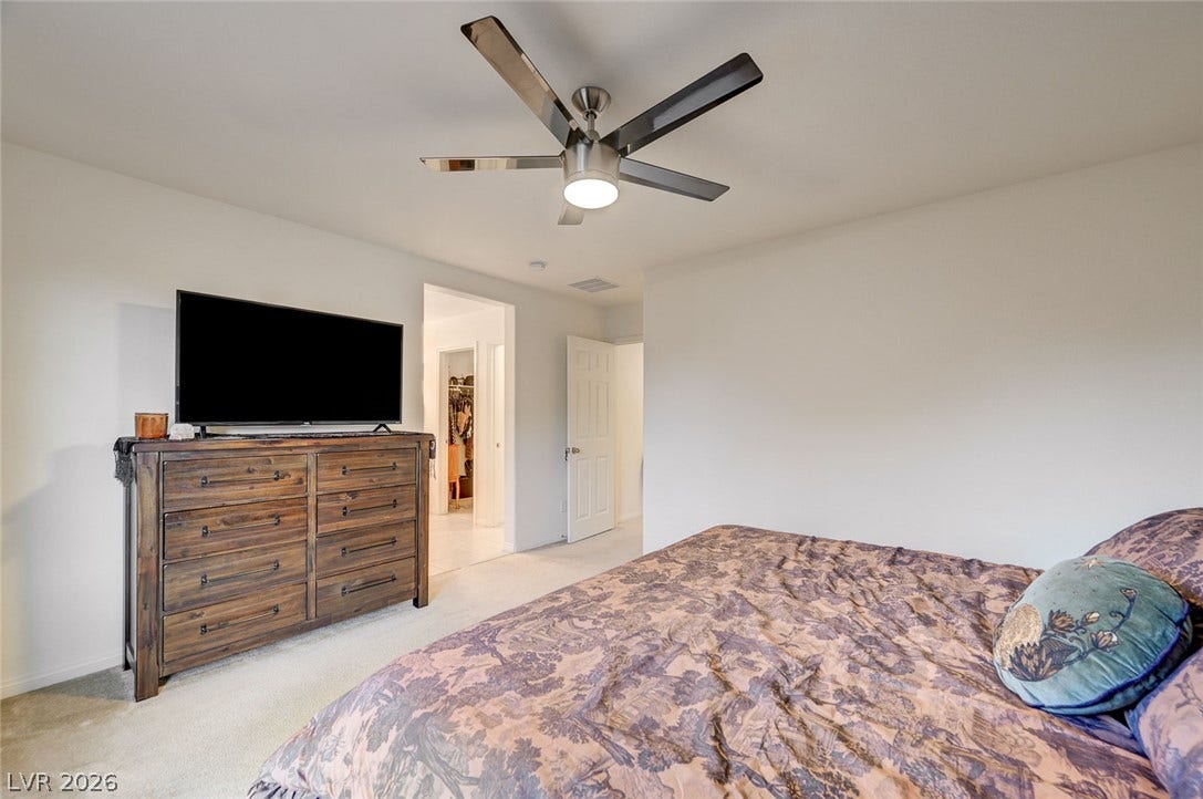 4114 Billowing Breeze Avenue, North Las Vegas, NV 89081 An inviting bedroom features plush carpeting and smooth neutral walls.