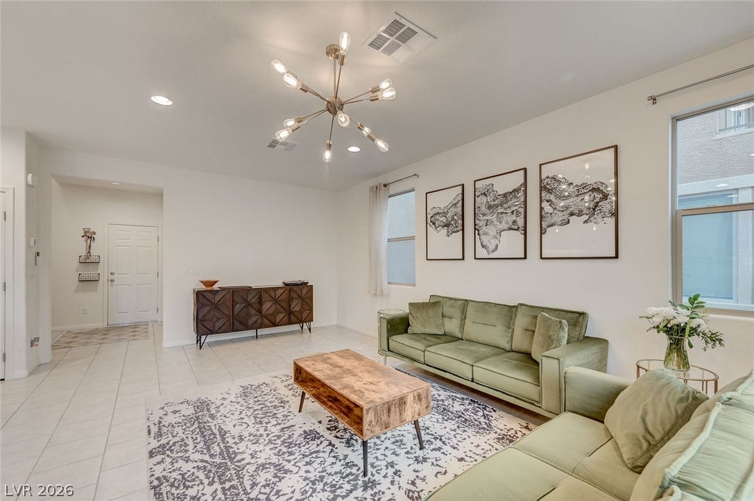 4114 Billowing Breeze Avenue, North Las Vegas, NV 89081 Smooth tile flooring, clean-lined walls, and abundant natural light define this inviting gathering space.