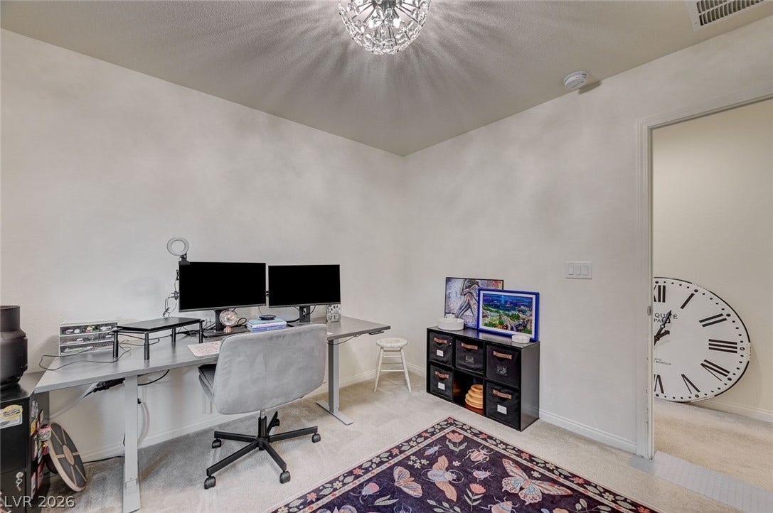 4114 Billowing Breeze Avenue, North Las Vegas, NV 89081 Smooth walls and soft carpet flooring define this versatile home workspace.