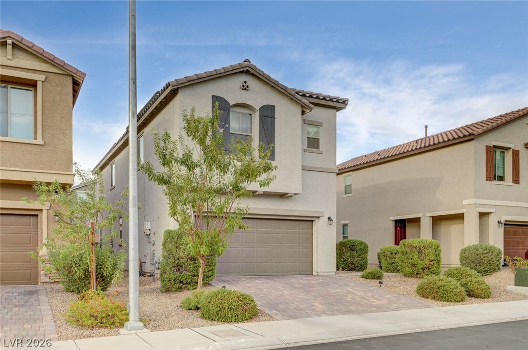 4114 Billowing Breeze Avenue, North Las Vegas, NV 89081 Mediterranean-inspired stucco architecture defines this elegant multi-level residence with paver driveway.