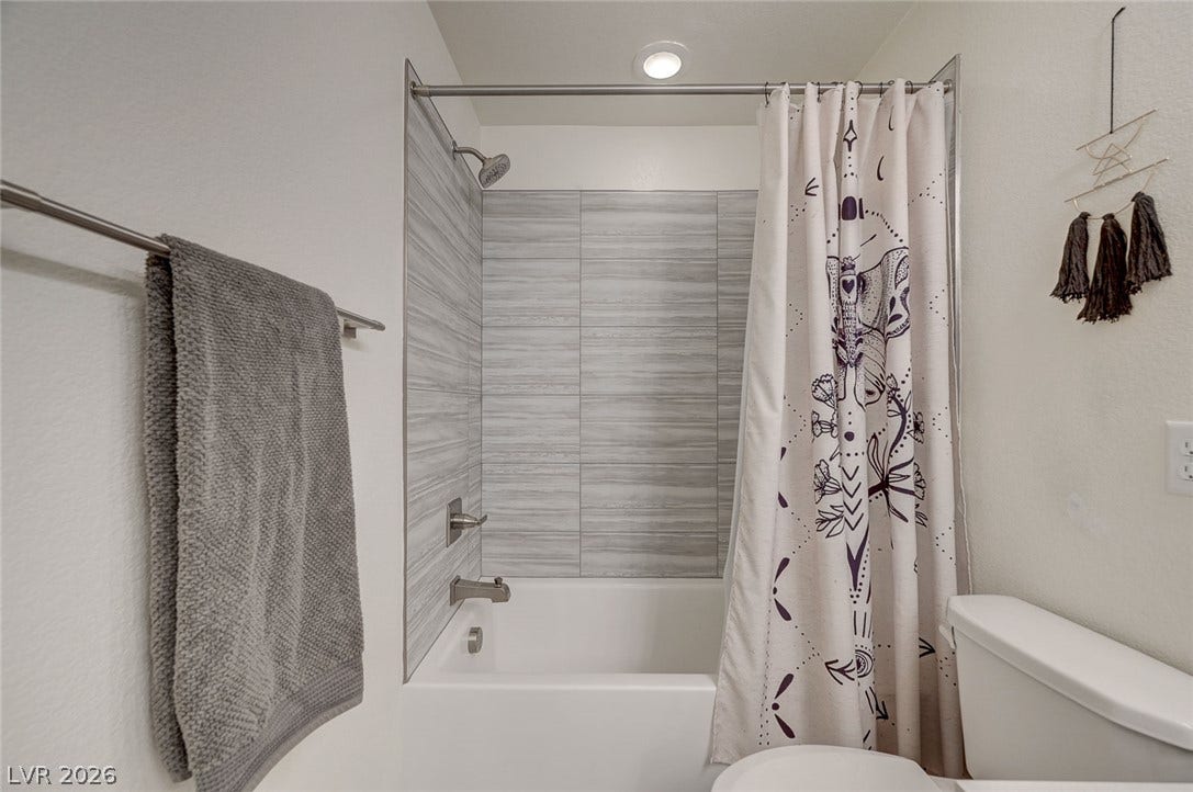 4114 Billowing Breeze Avenue, North Las Vegas, NV 89081 A modern tiled tub surround highlights this clean secondary bathroom space.