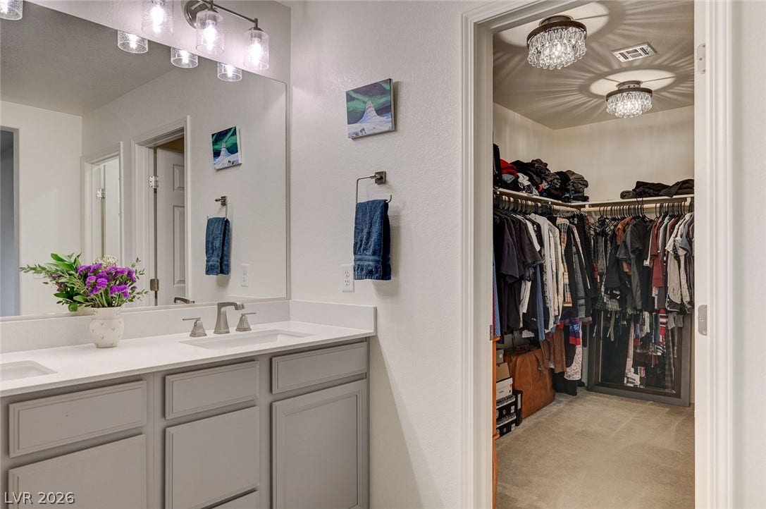 4114 Billowing Breeze Avenue, North Las Vegas, NV 89081 An elegant double vanity bathroom connects seamlessly to a spacious walk-in closet.