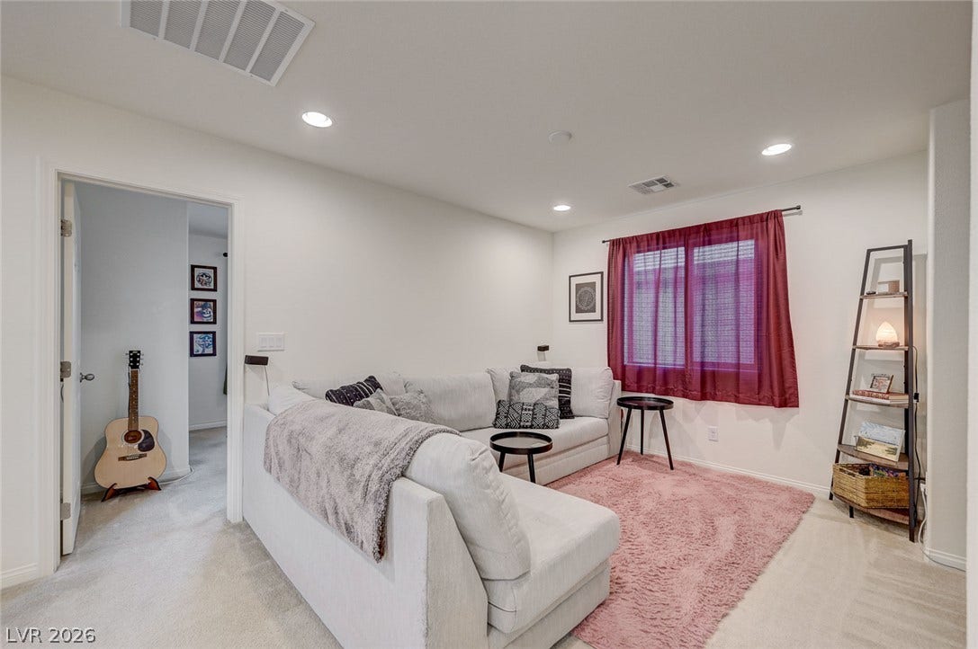 4114 Billowing Breeze Avenue, North Las Vegas, NV 89081 Recessed lighting and soft carpeting create a cozy, inviting atmosphere in this versatile living space.
