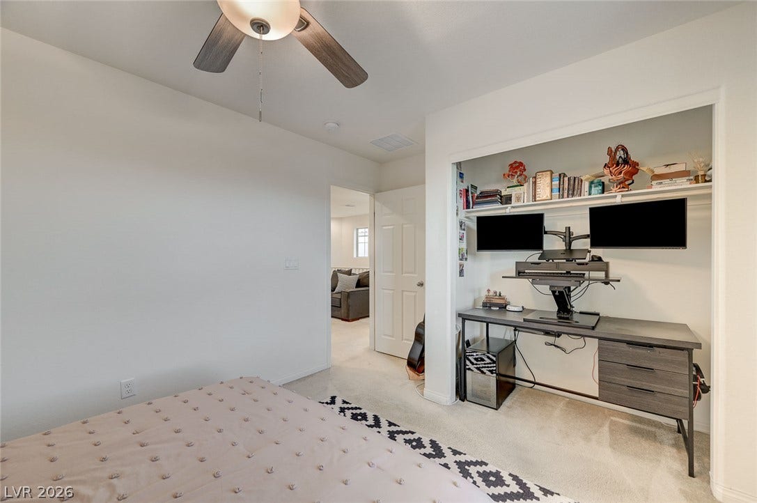 4114 Billowing Breeze Avenue, North Las Vegas, NV 89081 A versatile bedroom features carpeted flooring and a built-in closet alcove.