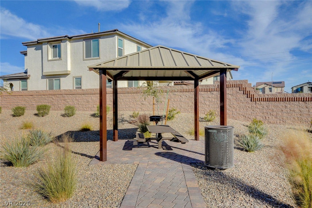 4114 Billowing Breeze Avenue, North Las Vegas, NV 89081 A sheltered pavilion with paving stone pathways anchors this landscaped desert courtyard.