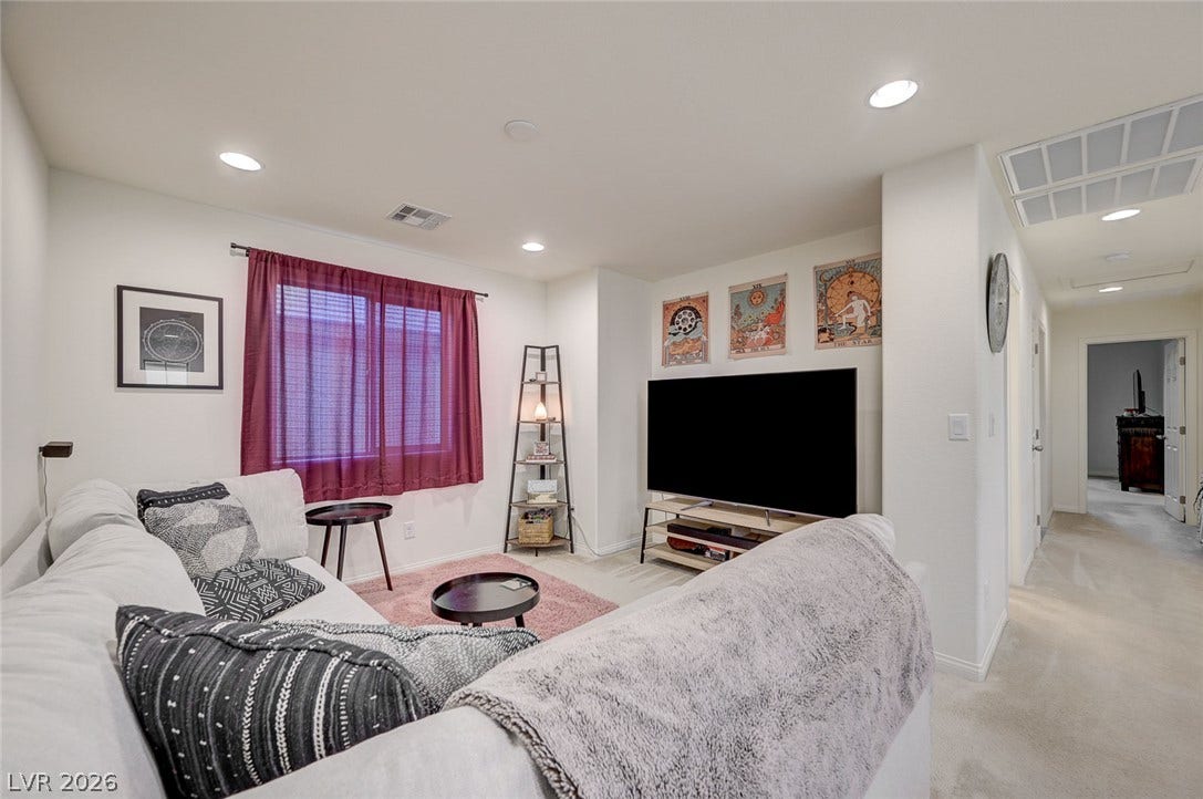 4114 Billowing Breeze Avenue, North Las Vegas, NV 89081 Recessed lighting and soft carpet floor define this comfortable living area.