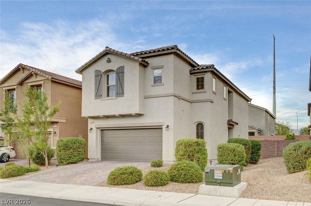4114 Billowing Breeze Avenue, North Las Vegas, NV 89081 Elegant two-story exterior showcases classic stucco architecture paired with a tile roof.