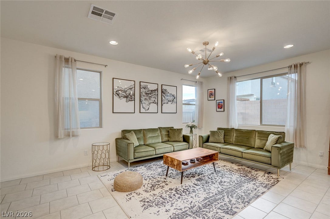 4114 Billowing Breeze Avenue, North Las Vegas, NV 89081 Tiled floors and multiple windows create an open, airy feel in this modern living room.