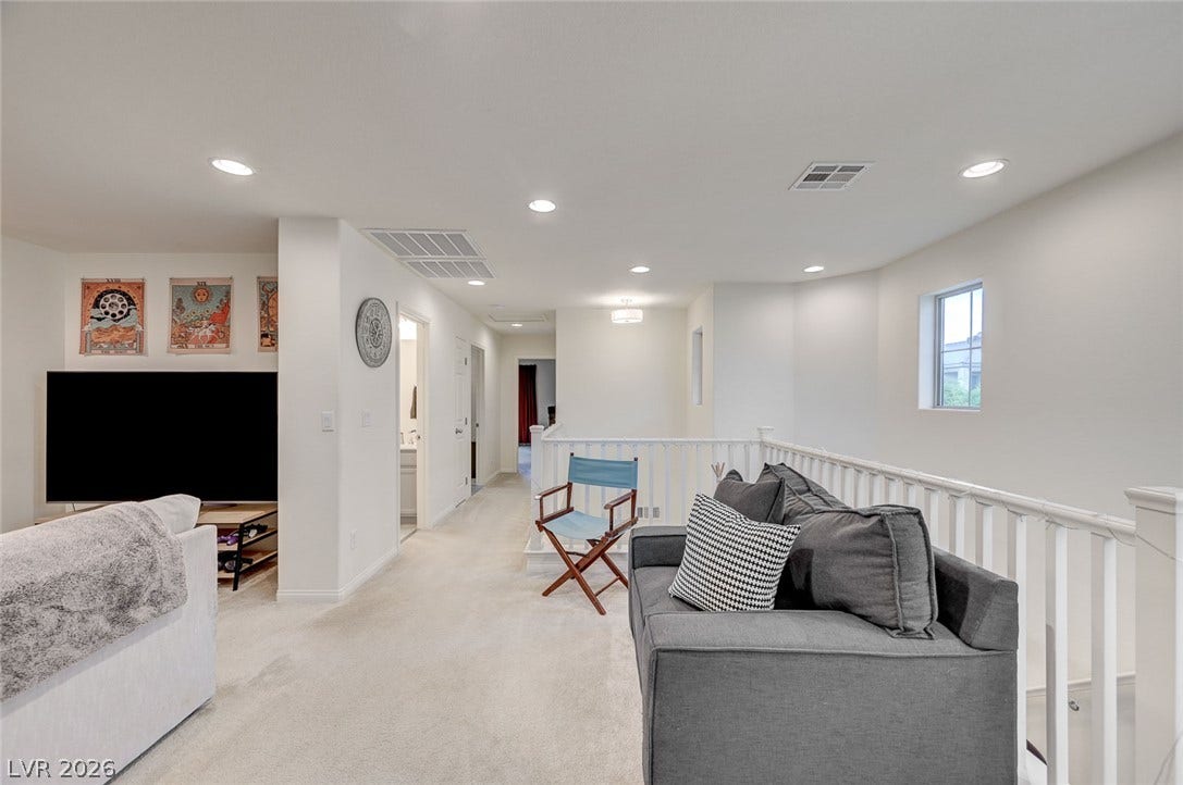 4114 Billowing Breeze Avenue, North Las Vegas, NV 89081 An upper level loft area boasts neutral carpeting and recessed lighting near the staircase landing.