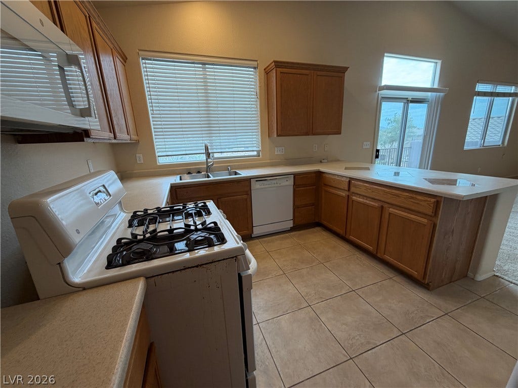 6420 W Casamar Street, North Las Vegas, NV 89086 Ample wooden cabinetry and tile flooring define this open kitchen space.