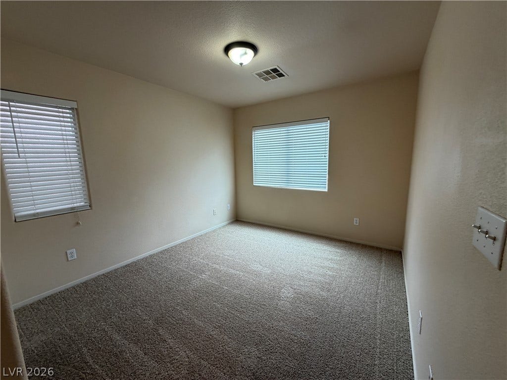 6420 W Casamar Street, North Las Vegas, NV 89086 Plush wall-to-wall carpeting and multiple windows define this versatile secondary bedroom space.