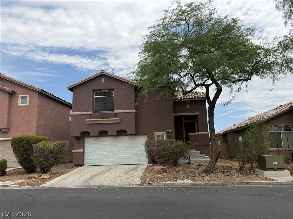 6420 W Casamar Street, North Las Vegas, NV 89086 Earth-toned stucco architecture defines this multi-level exterior complete with an attached two-car garage.