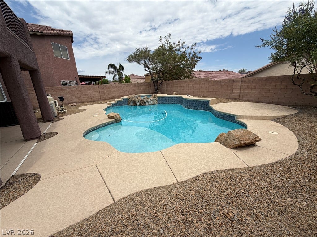 6420 W Casamar Street, North Las Vegas, NV 89086 An inviting backyard oasis showcases a sparkling pool framed by stone accents and gravel landscaping.