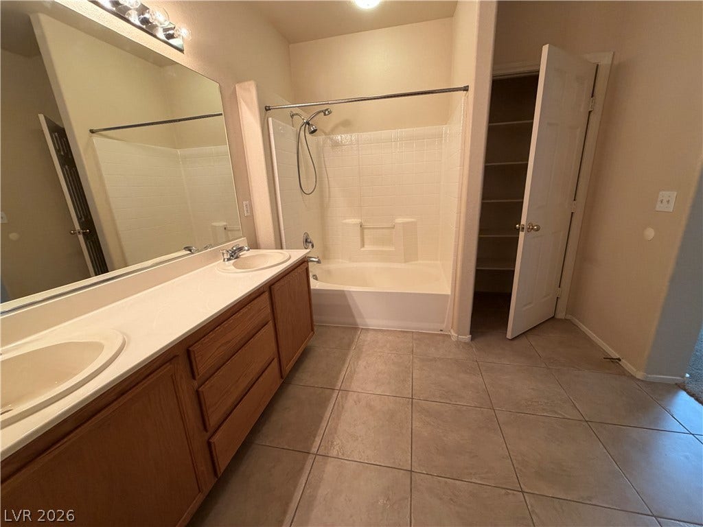 6420 W Casamar Street, North Las Vegas, NV 89086 A spacious vanity and tile flooring define this functional bathroom layout.