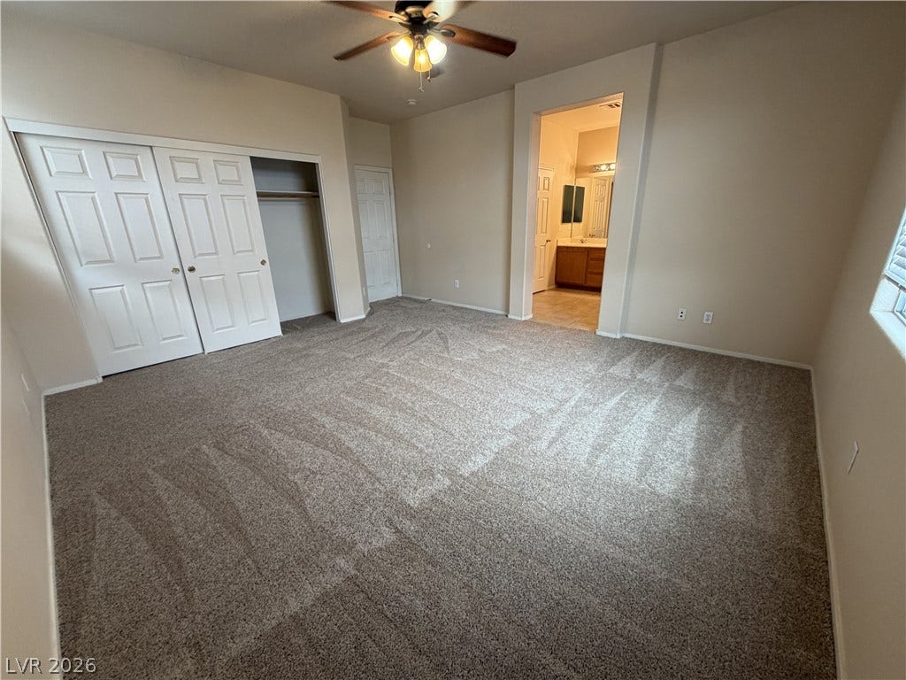 6420 W Casamar Street, North Las Vegas, NV 89086 An open doorway leads from this carpeted bedroom directly into the adjacent bathroom.