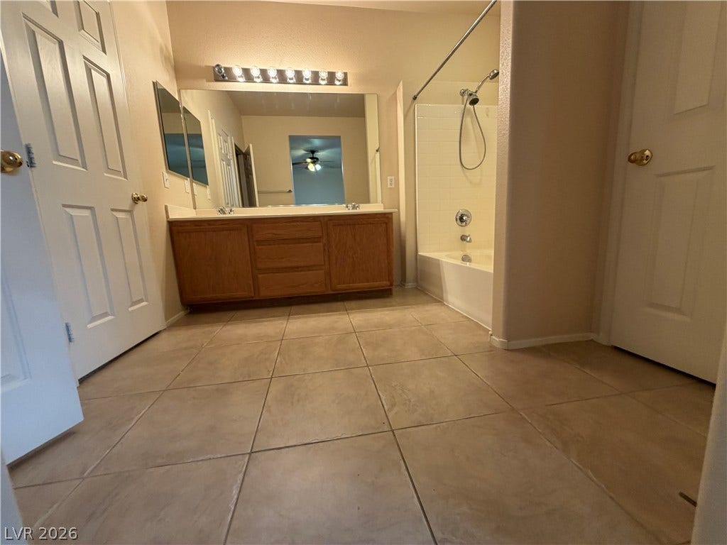 6420 W Casamar Street, North Las Vegas, NV 89086 Tiled flooring and a spacious vanity complete this functional bathroom layout.