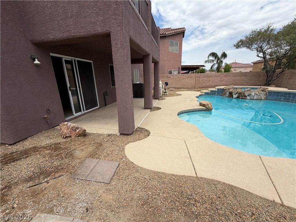 6420 W Casamar Street, North Las Vegas, NV 89086 A sparkling swimming pool highlights this backyard with its covered patio and stone-lined spa.