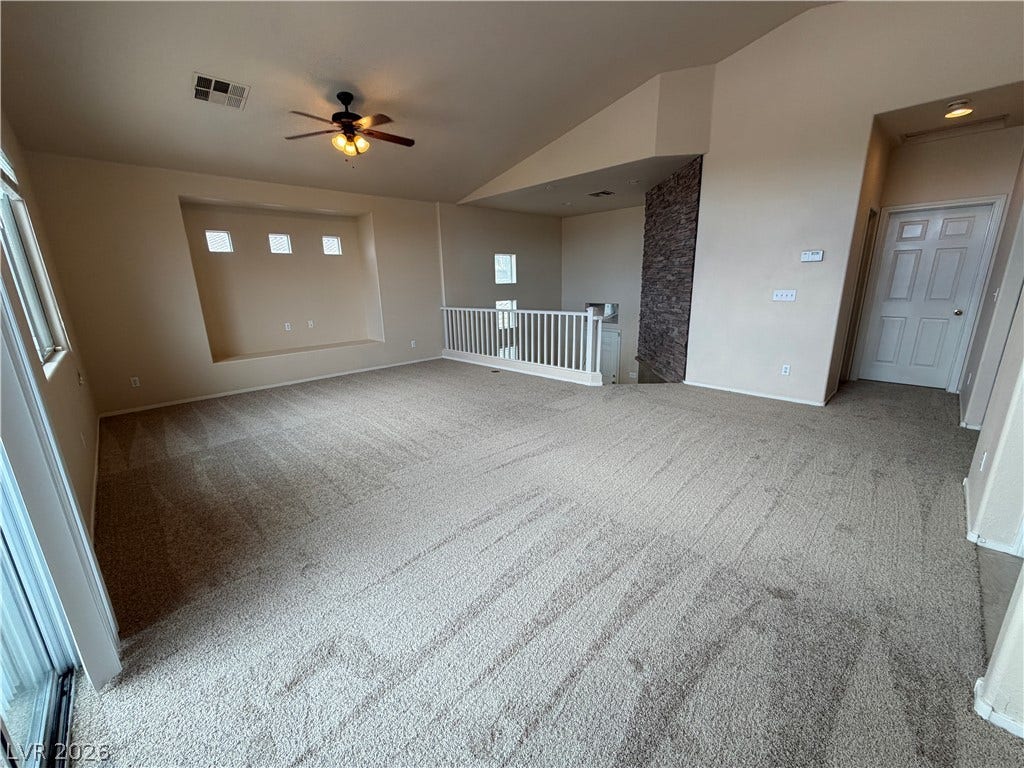 6420 W Casamar Street, North Las Vegas, NV 89086 Vaulted ceilings and soft carpeting define this versatile upper-level loft space.