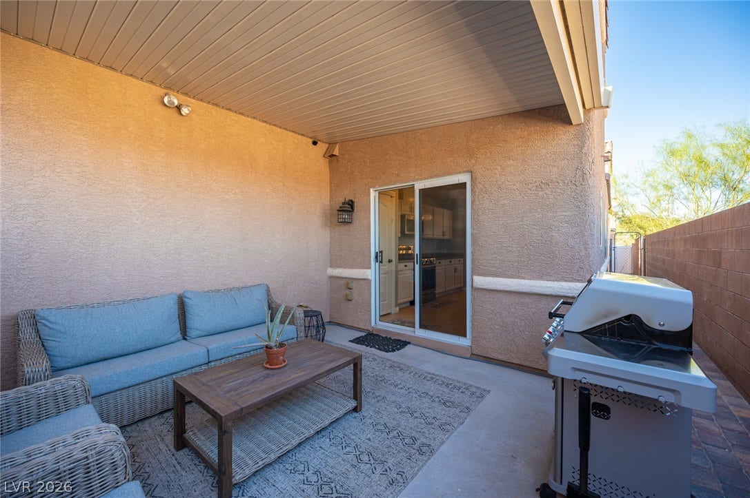 A covered concrete patio provides sheltered outdoor living space adjacent to the kitchen.