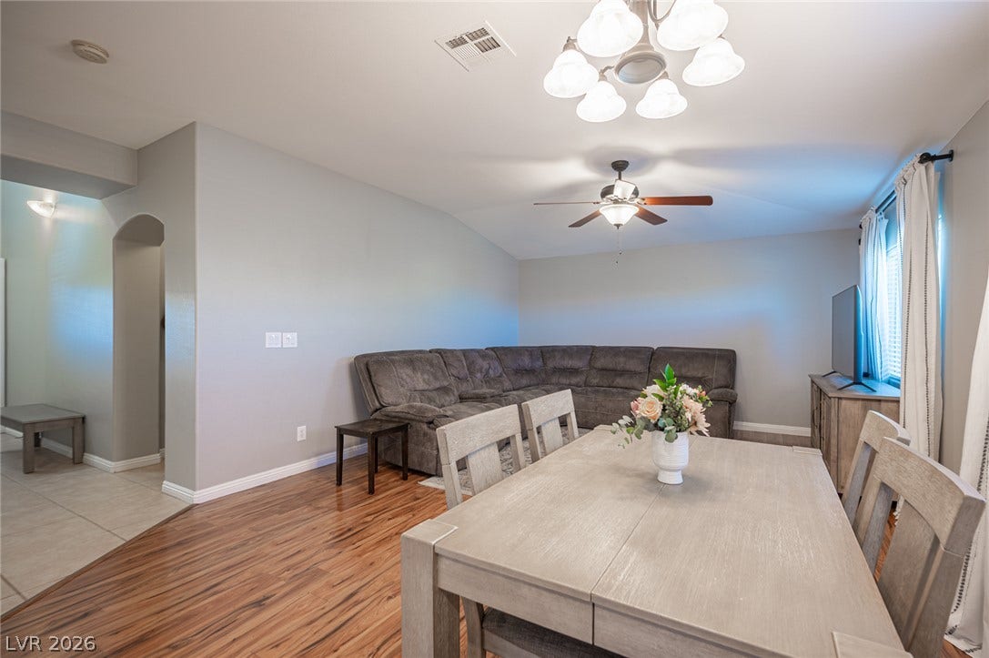 Gleaming wood floors anchor this open-concept dining area that seamlessly transitions into the living space.