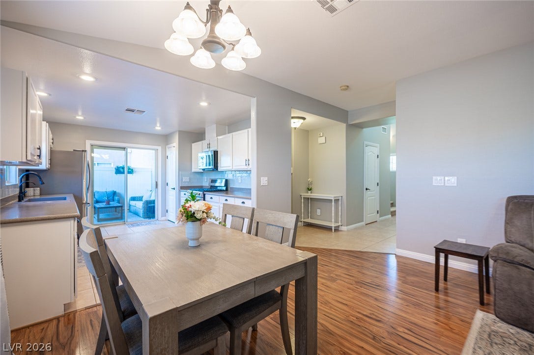 Warm wood flooring flows seamlessly through an airy, open layout with recessed lighting.