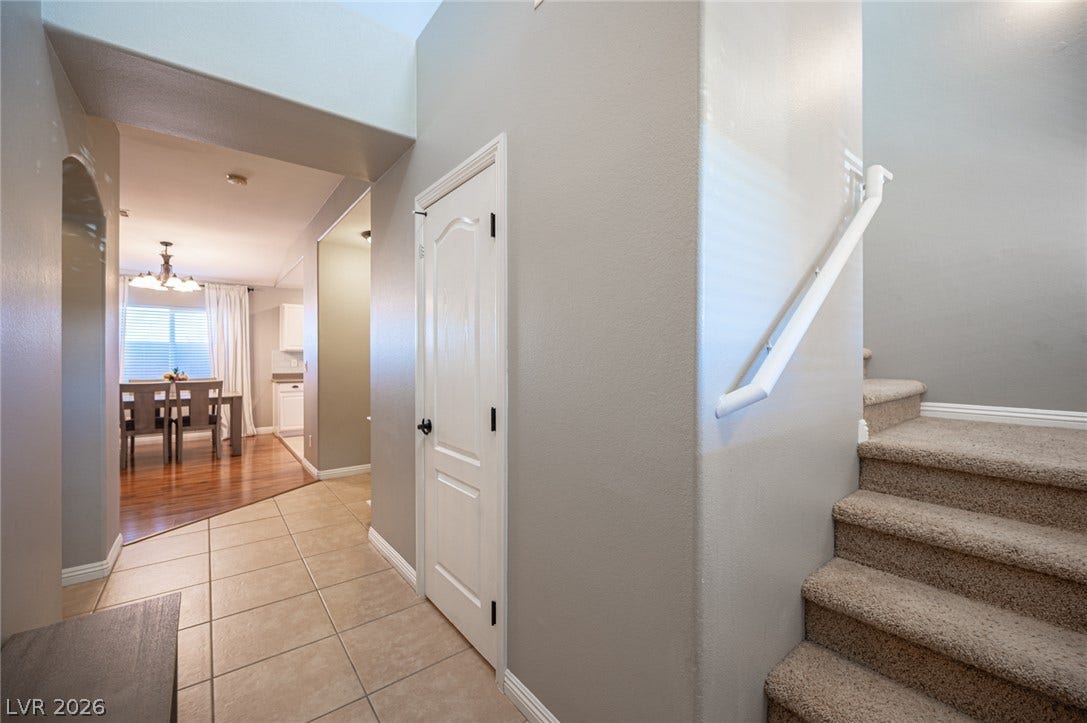 High ceilings and a neutral tile entryway connect the living levels seamlessly.