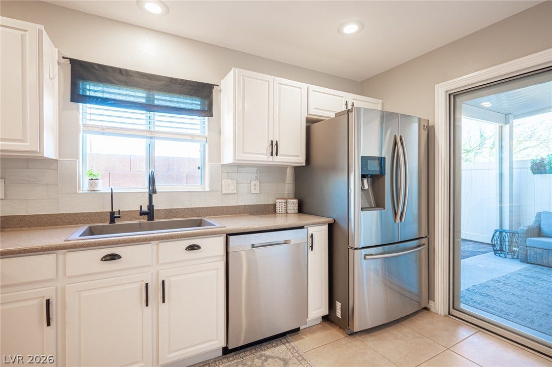 A sliding glass door opens to the patio from this updated kitchen.