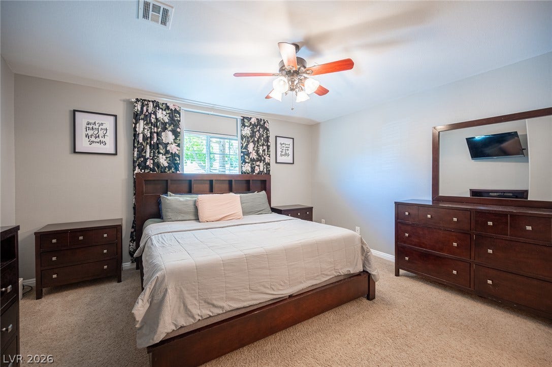 Plush carpeting and large windows create a comfortable and relaxing atmosphere in this bedroom.