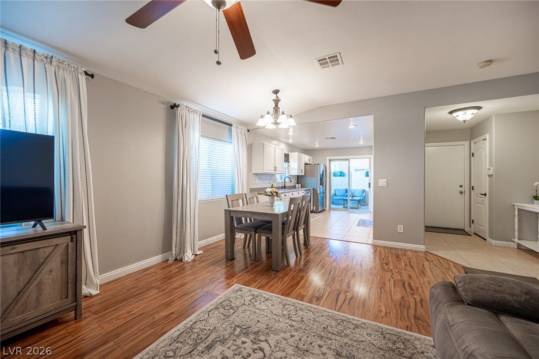 Gleaming wood floors flow through this light-filled open concept dining and living space.