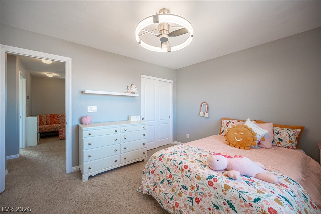Plush wall-to-wall carpeting and clean moldings anchor this comfortable secondary bedroom space.