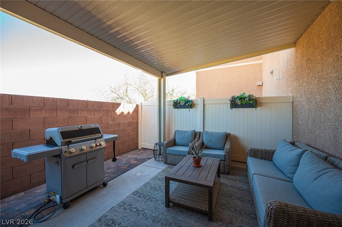 An inviting covered patio offers a private outdoor retreat with durable concrete flooring.