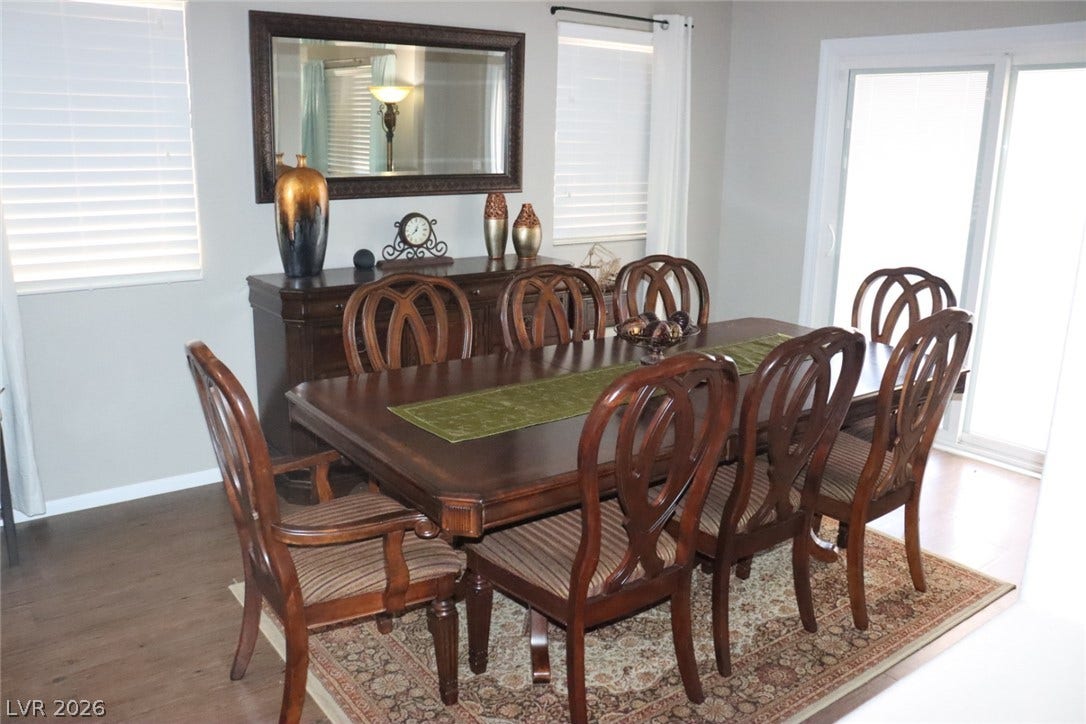 Natural light pours across the wood flooring from a sliding glass door.