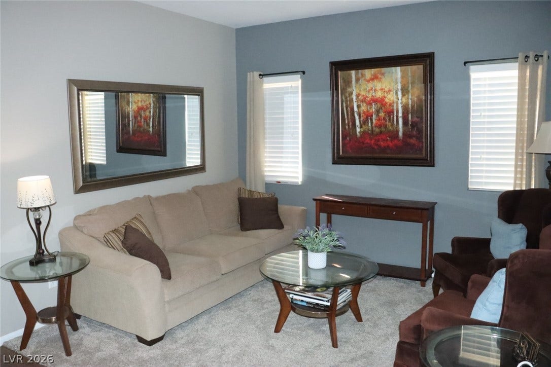 Plush wall-to-wall carpeting and twin windows create a comfortable living space.