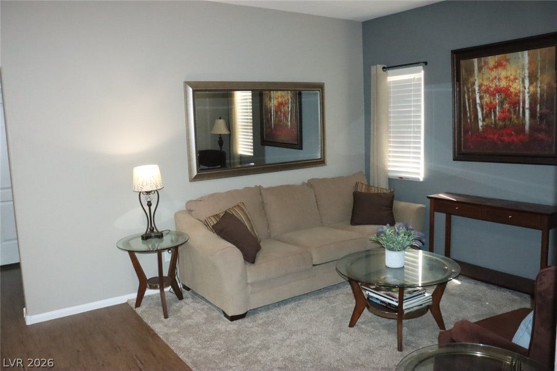 Smooth drywall finishes and wood-look flooring establish a relaxed interior ambiance.
