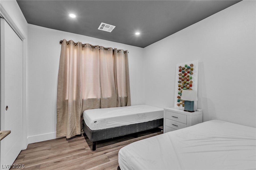 4170 Sheppard Drive, Las Vegas, NV 89121 Gleaming wood-look floors complement the clean lines and recessed lighting of this modern bedroom.