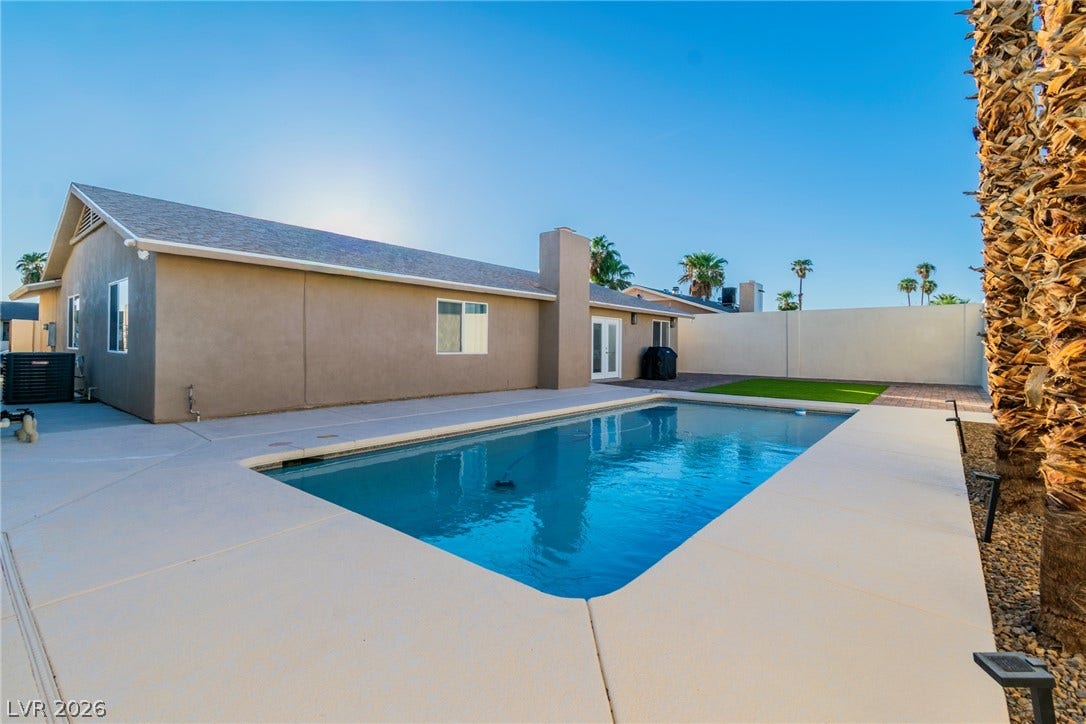 4170 Sheppard Drive, Las Vegas, NV 89121 An inviting backyard features a sparkling swimming pool surrounded by a spacious concrete patio.