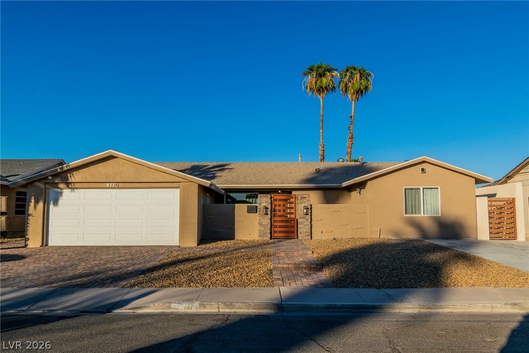 4170 Sheppard Drive, Las Vegas, NV 89121 Mid-century modern desert home featuring a gated courtyard entrance and paver driveway.